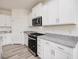 Kitchen with white cabinets, stainless steel appliances, and gray granite countertops at 107 Willow Cameron Way, Angier, NC 27501