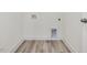 Dedicated laundry area with wood-look flooring and utility connections at 107 Willow Cameron Way, Angier, NC 27501