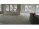 Bright, open living room with large windows showcasing the surrounding neighborhood views at 107 Willow Cameron Way, Angier, NC 27501