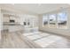 Open-concept living area with a modern kitchen, large windows and wood-look flooring at 107 Willow Cameron Way, Angier, NC 27501
