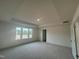 Large main bedroom with tray ceiling and multiple windows at 107 Willow Cameron Way, Angier, NC 27501