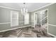 Elegant dining room featuring a crystal chandelier and stylish herringbone floors at 108 Boxford Rd, Morrisville, NC 27560