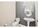 Bathroom with toilet and sink with pedestal, featuring modern fixtures and decor at 11213 Presidio Dr, Raleigh, NC 27617