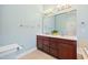 Bright bathroom featuring a double sink vanity, large mirror, and classic fixtures at 11213 Presidio Dr, Raleigh, NC 27617