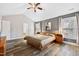 Spacious primary bedroom featuring vaulted ceiling, and natural light from the window with wood flooring at 11213 Presidio Dr, Raleigh, NC 27617