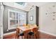 Cozy dining area with a wooden table, chairs, skylight, and large window at 11213 Presidio Dr, Raleigh, NC 27617