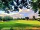 Expansive green golf course view with trees in the background at 11213 Presidio Dr, Raleigh, NC 27617
