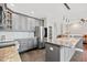 Elegant kitchen showcasing gray cabinets, granite counters, and stainless steel appliances at 11213 Presidio Dr, Raleigh, NC 27617
