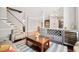 Open concept living area with hardwood floors, stylish bar and modern staircase at 11213 Presidio Dr, Raleigh, NC 27617