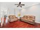 Spacious living room with hardwood floors, ceiling fan, and comfortable couches at 11213 Presidio Dr, Raleigh, NC 27617