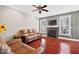 Cozy living room with a fireplace, hardwood floors, and comfortable leather seating at 11213 Presidio Dr, Raleigh, NC 27617