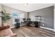 Bright office featuring a modern desk, ample storage, and a large window for natural light with wood flooring at 11213 Presidio Dr, Raleigh, NC 27617