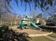 Community playground with green and yellow slides sits on a mulch bed at 11213 Presidio Dr, Raleigh, NC 27617