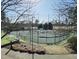 Well-maintained tennis court framed by trees and greenery at 11213 Presidio Dr, Raleigh, NC 27617