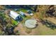 Aerial view of horse farm with round pen, outbuildings, and white fencing at 11705 Appaloosa E, Raleigh, NC 27613