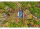 Aerial view of home nestled among trees with colorful foliage at 11705 Appaloosa E, Raleigh, NC 27613
