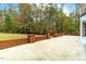 Backyard patio with short brick wall bordering the grassy lawn and treeline at 11705 Appaloosa E, Raleigh, NC 27613