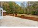 Brick patio with low brick walls, grassy backyard and beautiful trees at 11705 Appaloosa E, Raleigh, NC 27613
