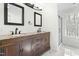 Bathroom boasting a dual sink dark wood vanity, marble floors, and walk-in shower at 11705 Appaloosa E, Raleigh, NC 27613