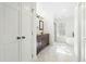 Elegant bathroom with dual sink dark wood vanity, marble floors, tub, and glass enclosed shower at 11705 Appaloosa E, Raleigh, NC 27613