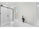 Bright bathroom features a glass shower and soaking tub with double windows at 11705 Appaloosa E, Raleigh, NC 27613
