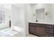 Bathroom features a vanity with dark wood cabinets, white countertop and tiled floors at 11705 Appaloosa E, Raleigh, NC 27613