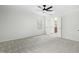 Light-filled bedroom with open doorway to bathroom featuring a dark vanity at 11705 Appaloosa E, Raleigh, NC 27613