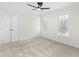 This bedroom features a ceiling fan, carpet, double windows, and white trim at 11705 Appaloosa E, Raleigh, NC 27613