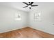 Bright bedroom featuring hardwood floors, a ceiling fan and two windows overlooking the backyard at 11705 Appaloosa E, Raleigh, NC 27613