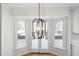 Dining area with modern chandelier and view of the outdoor patio through the double doors at 11705 Appaloosa E, Raleigh, NC 27613