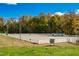 Equestrian arena with mature tree line, white perimeter fence, and well-maintained arena surface at 11705 Appaloosa E, Raleigh, NC 27613