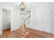 Bright hallway with hardwood floors, classic trim, and a view of the staircase leading to the next level at 11705 Appaloosa E, Raleigh, NC 27613