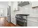 Bright kitchen features modern appliances, stainless refrigerator and a gas range stove at 11705 Appaloosa E, Raleigh, NC 27613