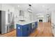 Kitchen features stainless appliances, a blue island, and an open view into the living area at 11705 Appaloosa E, Raleigh, NC 27613