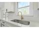 Kitchen features modern white countertops, stainless steel sink, and sleek golden faucet fixture at 11705 Appaloosa E, Raleigh, NC 27613