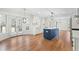 Spacious kitchen features white cabinets, stainless appliances, a blue island, and hardwood floors at 11705 Appaloosa E, Raleigh, NC 27613