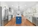Kitchen boasts stainless appliances, a blue island and a view into the living area with fireplace at 11705 Appaloosa E, Raleigh, NC 27613