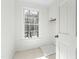 Well lit laundry room with storage cabinets, tile flooring, and window to the backyard at 11705 Appaloosa E, Raleigh, NC 27613