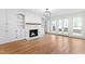 Bright living room featuring a fireplace with built-in shelves, hardwood floors and glass doors to the backyard at 11705 Appaloosa E, Raleigh, NC 27613