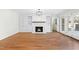 Stylish living room with a fireplace, built-in shelving, hardwood floors and access to the backyard at 11705 Appaloosa E, Raleigh, NC 27613