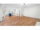 Spacious open-concept living room with hardwood floors and modern lighting flows into kitchen at 11705 Appaloosa E, Raleigh, NC 27613