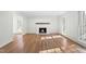 Inviting living room with a cozy fireplace, natural light, and gleaming hardwood floors at 11705 Appaloosa E, Raleigh, NC 27613
