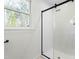 Close up of a shower with white subway tile and a modern black-framed glass door at 11705 Appaloosa E, Raleigh, NC 27613