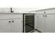 Close-up of wet bar featuring wine fridge, stone countertop, and modern cabinetry at 11705 Appaloosa E, Raleigh, NC 27613