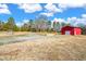 Red barn and sheds on a spacious lot under a blue sky at 1211 Palmers Chapel Church Rd, Siler City, NC 27344