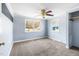 Bedroom featuring neutral carpet, light blue walls, a ceiling fan, and windows for natural light at 1211 Palmers Chapel Church Rd, Siler City, NC 27344