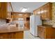 Efficient kitchen featuring wooden cabinets, laminate countertops and white appliances at 135 Rainbow Dr, Dunn, NC 28334