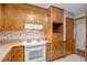 Kitchen with wooden cabinets and a white oven at 135 Rainbow Dr, Dunn, NC 28334