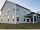 Home's exterior with a covered patio and sliding glass doors opening onto the backyard at 135 Willow Cameron Way, Angier, NC 27501
