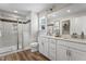 Clean, bright bathroom featuring a double vanity, tiled shower, and contemporary fixtures at 135 Willow Cameron Way, Angier, NC 27501